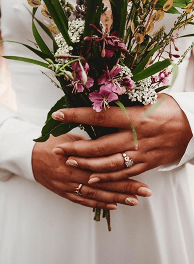 Hands holding wildflowers